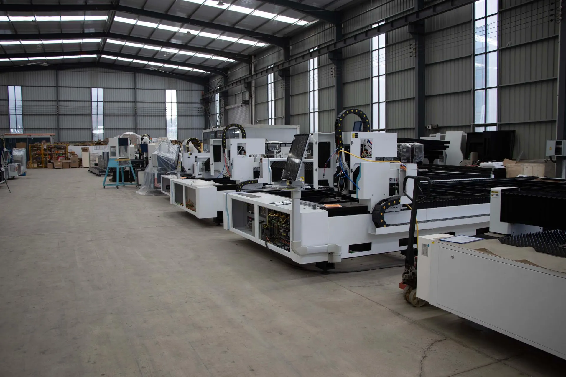 Rows of CNC machining centres in an industrial hall