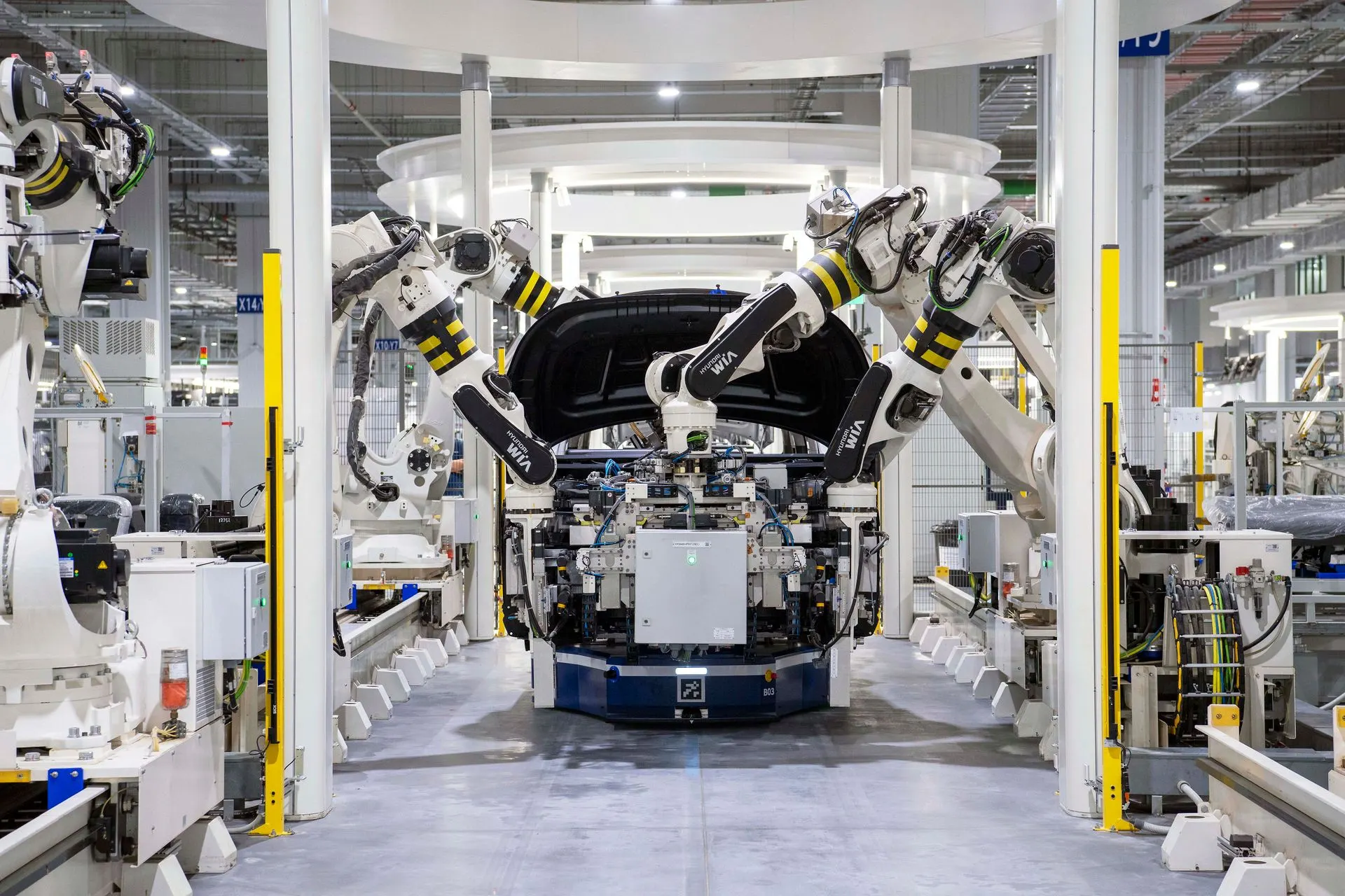 Robotic arms on an automated assembly line